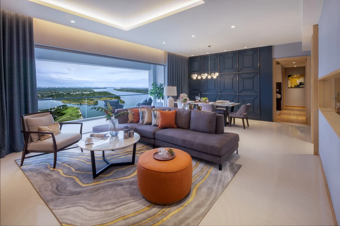 Living and dining area with a panoramic waterway view at Southern Marina Residences